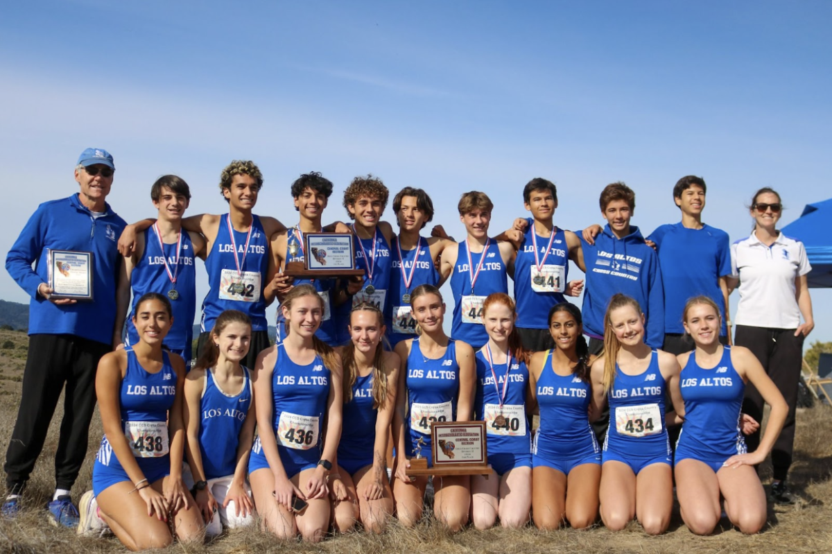 The boys and girls cross country teams pose alongside their coaches with their first and second-place plaques (respectively). This is the second year in a row both teams have placed in the top three. 